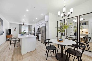 an open kitchen and dining area with a table and chairs
